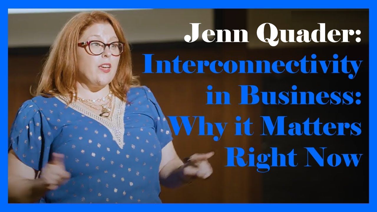 Jenn Quader presenting Interconnectivity in Business, title slide behind her.