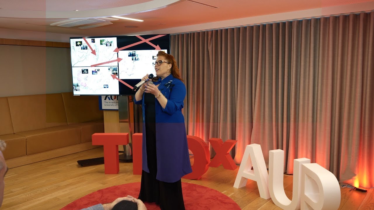 Jenn Quader on the red TEDx stage at The American University of Paris.